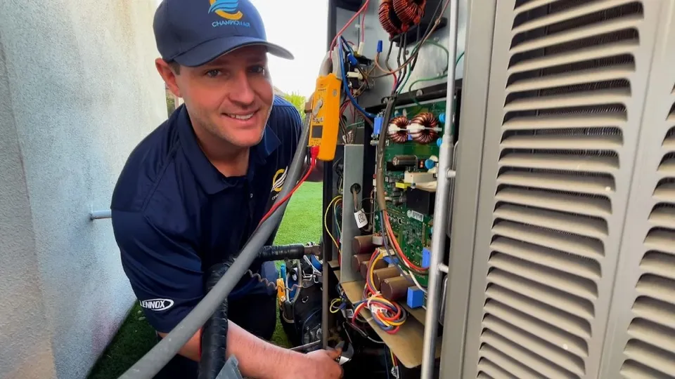 Champion Air technician servicing an AC unit