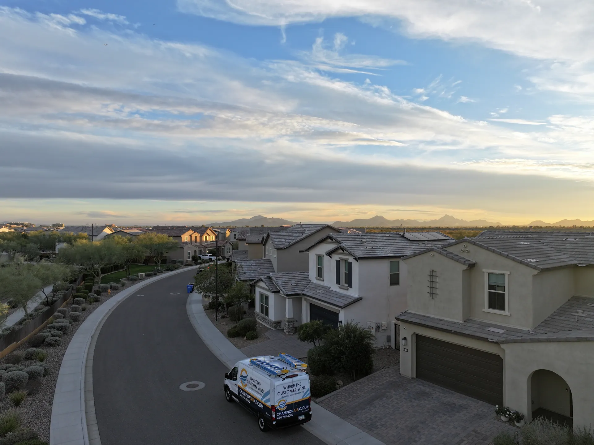 Champion Air service van in a Phoenix neighborhood at sunset